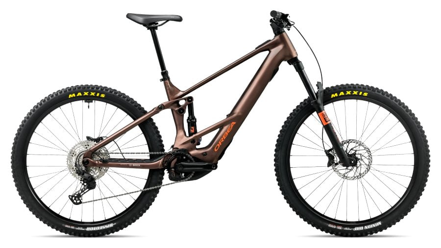 A full-suspension electric mountain bike in a metallic bronze color, featuring a black frame, black Maxxis tires, and a black saddle, shown against a plain white background.